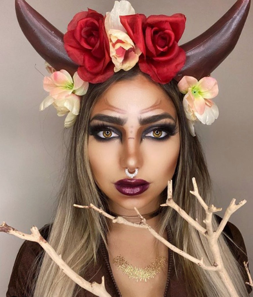 Image of a woman with bull-inspired makeup. 